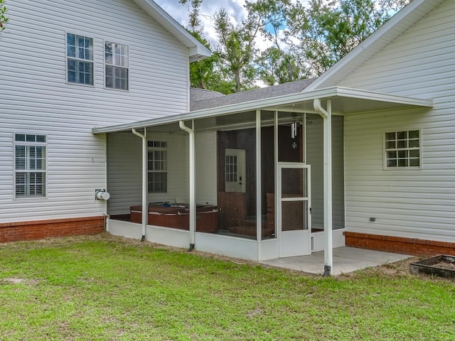 rear view of house featuring a sunroom and a yard