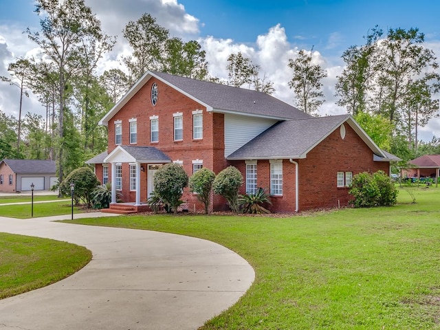 view of front of property featuring a garage and a front lawn