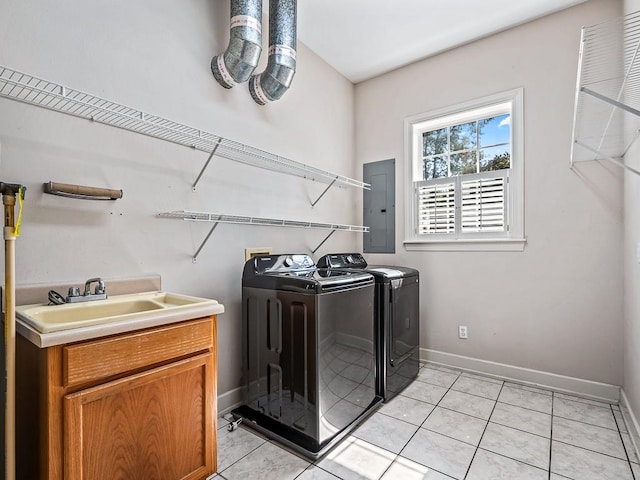 laundry room featuring electric panel, cabinets, sink, light tile patterned flooring, and washing machine and dryer