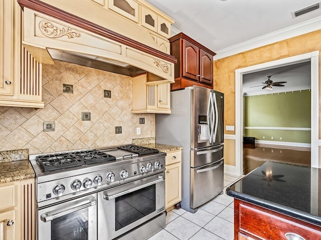 127 Bullen Ln, Perry, FL 32347 - kitchen featuring stainless steel appliances, cream cabinetry, custom exhaust hood, a ceiling fan, and backsplash