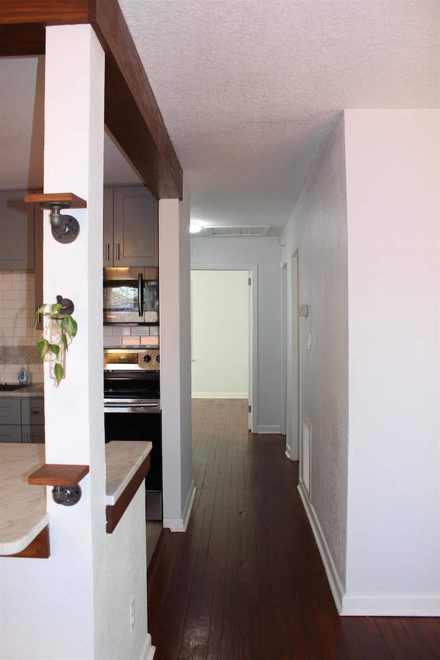 837 Dent St, Tallahassee, FL 32304 - corridor with baseboards, visible vents, dark wood-type flooring, and a textured ceiling