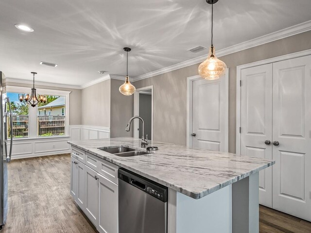1666 Landing St, Carrabelle, FL 32322 - kitchen featuring appliances with stainless steel finishes, a sink, wood finished floors, light stone counters, and a chandelier
