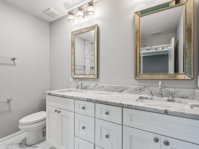 1666 Landing St, Carrabelle, FL 32322 - full bathroom featuring marble look tiles, toilet, double vanity, and baseboards