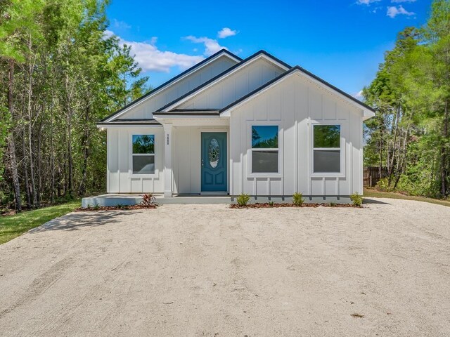 1666 Landing St, Carrabelle, FL 32322 - modern farmhouse style home featuring board and batten siding and covered porch