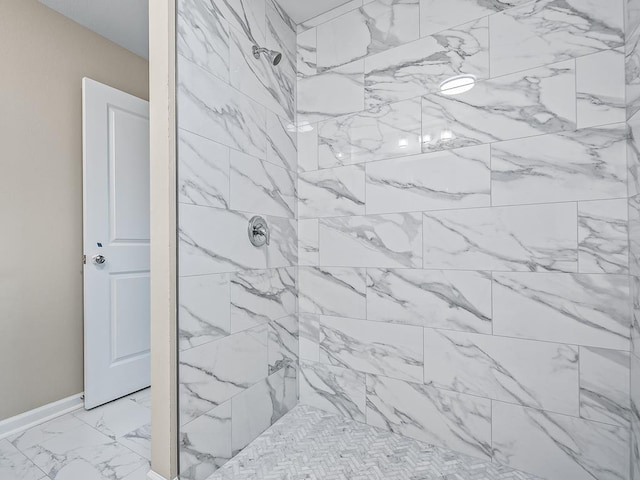 1666 Landing St, Carrabelle, FL 32322 - bathroom featuring tiled shower, marble look tiles, and baseboards