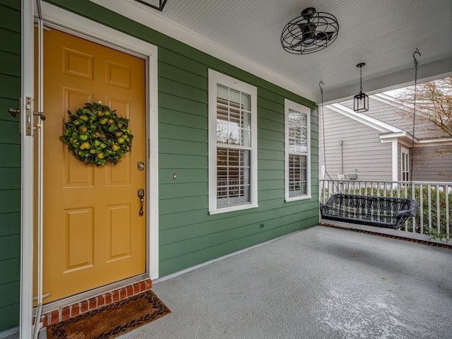 view of exterior entry with covered porch