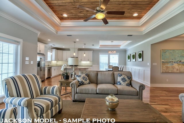 living room with light hardwood / wood-style flooring, wooden ceiling, ornamental molding, and a raised ceiling