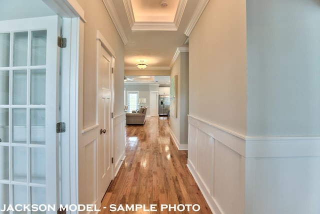 corridor featuring ornamental molding and wood-type flooring