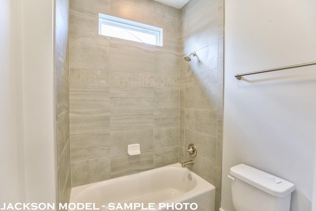 bathroom featuring toilet and tiled shower / bath combo