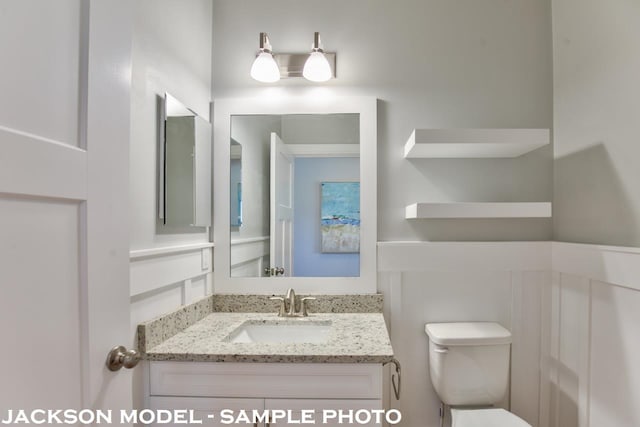 bathroom featuring vanity and toilet