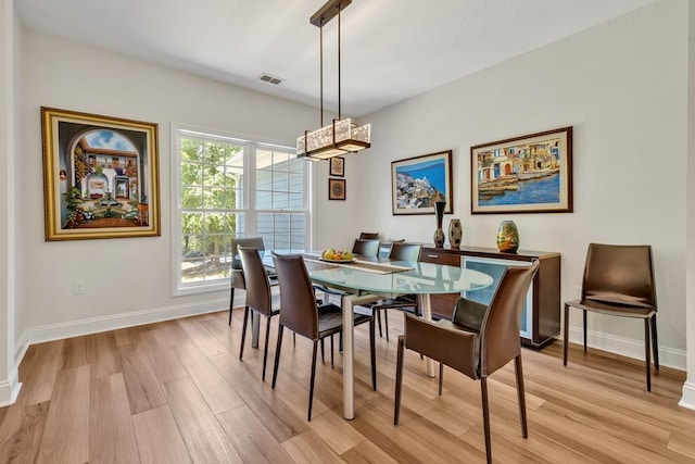 323 Carr Ln, Tallahassee, FL 32312 - dining space with light wood-style flooring, baseboards, and a chandelier