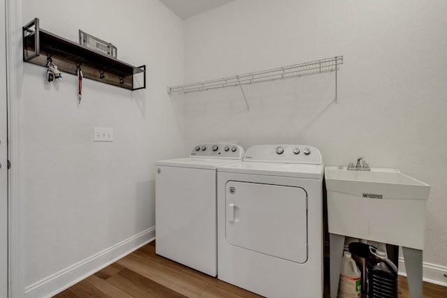 323 Carr Ln, Tallahassee, FL 32312 - clothes washing area with washing machine and clothes dryer, wood finished floors, and baseboards