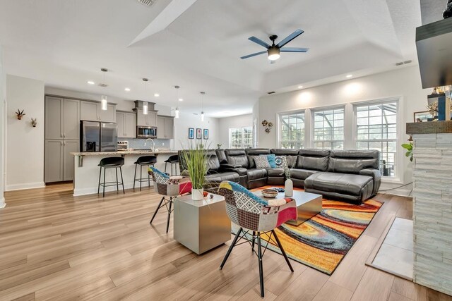 323 Carr Ln, Tallahassee, FL 32312 - living room featuring a tray ceiling, a ceiling fan, recessed lighting, light wood finished floors, and baseboards