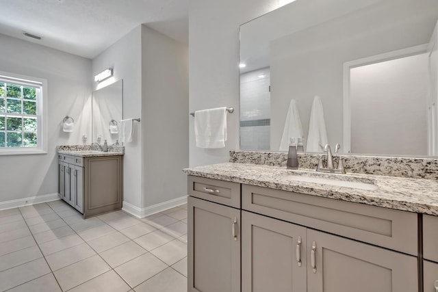 323 Carr Ln, Tallahassee, FL 32312 - full bathroom with baseboards, tile patterned floors, two vanities, and a tile shower