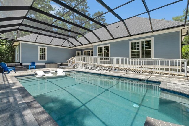 323 Carr Ln, Tallahassee, FL 32312 - outdoor pool featuring a patio, glass enclosure, and an outdoor hangout area