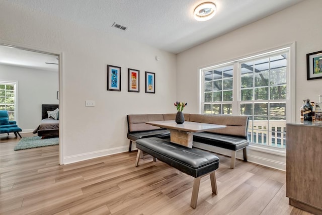 323 Carr Ln, Tallahassee, FL 32312 - dining space with light wood-type flooring, baseboards, and a textured ceiling