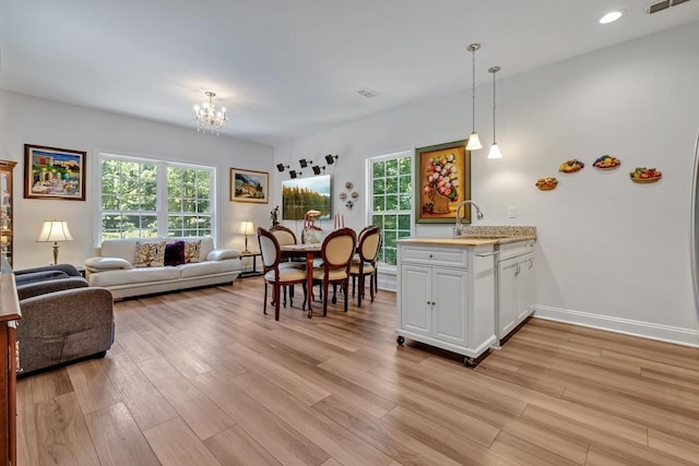 323 Carr Ln, Tallahassee, FL 32312 - living room featuring light wood-type flooring, a chandelier, plenty of natural light, and recessed lighting