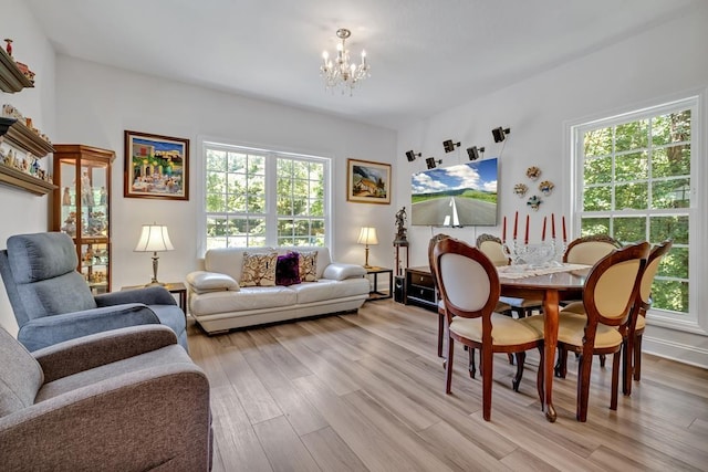 323 Carr Ln, Tallahassee, FL 32312 - living room featuring a chandelier, plenty of natural light, and light wood finished floors