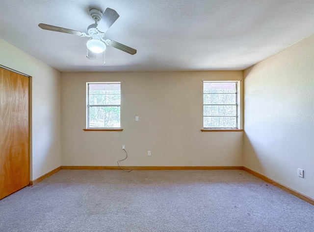 spare room with carpet and ceiling fan