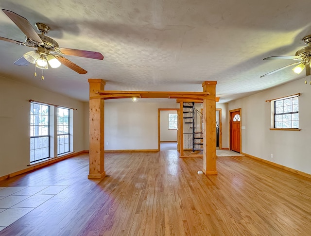 interior space featuring ceiling fan, a textured ceiling, and light hardwood / wood-style flooring