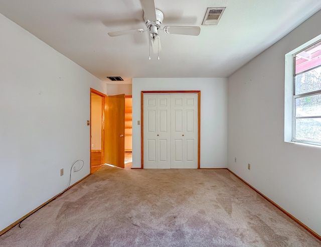 unfurnished bedroom with carpet floors, a closet, and ceiling fan