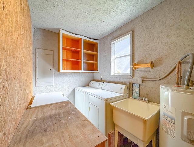 washroom featuring gas water heater, separate washer and dryer, sink, and electric panel