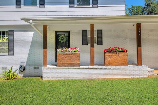 120 China Doll Dr, Tallahassee, FL 32312 - property entrance featuring covered porch, brick siding, and a yard