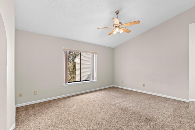 carpeted spare room with ceiling fan, a textured ceiling, and vaulted ceiling