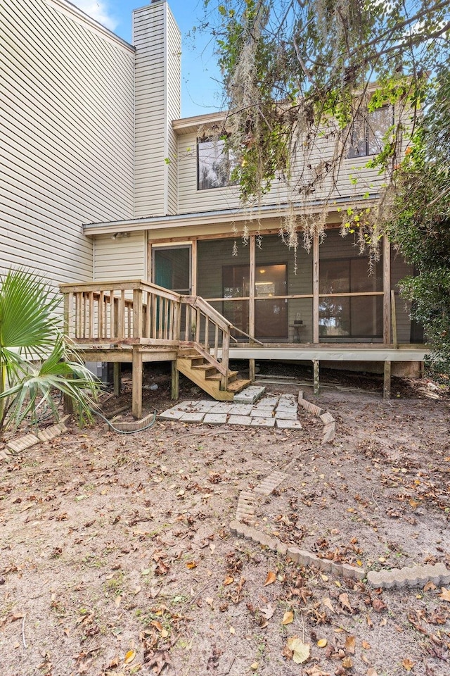 back of house with a sunroom