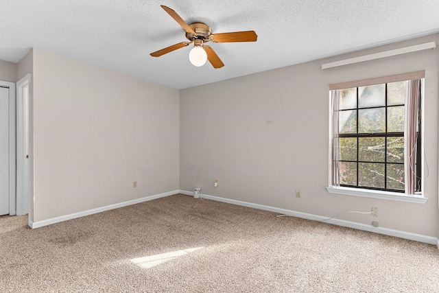 carpeted empty room with a textured ceiling and ceiling fan