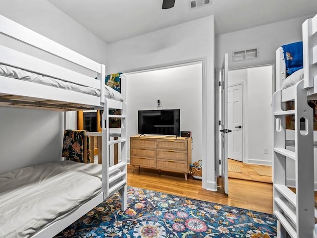 bedroom with ceiling fan and wood-type flooring