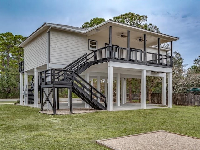 rear view of property with a lawn, ceiling fan, and a patio