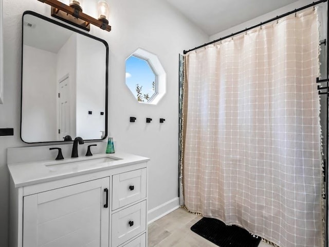 bathroom featuring hardwood / wood-style flooring and vanity