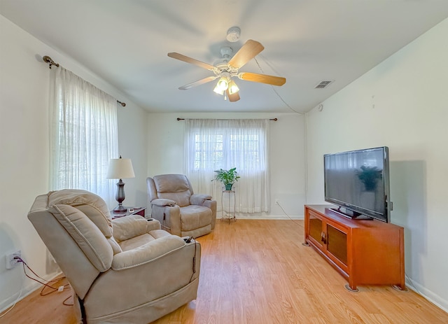 living room featuring light wood-type flooring and ceiling fan