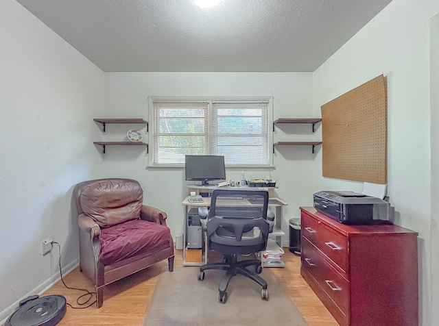 office with a textured ceiling and light hardwood / wood-style floors