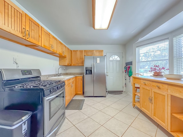 kitchen with light tile patterned flooring, sink, and appliances with stainless steel finishes