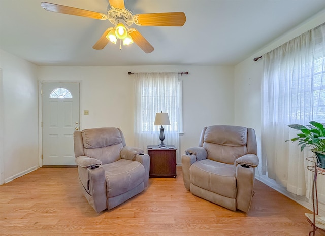 sitting room with ceiling fan and light hardwood / wood-style floors