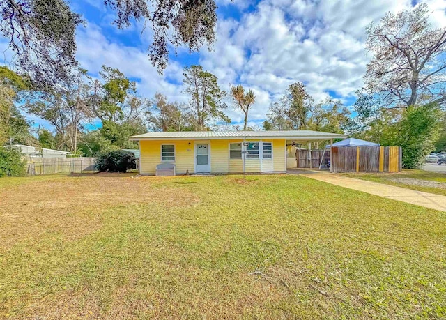 ranch-style house featuring a front yard and a carport