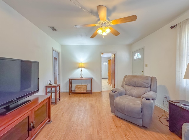 sitting room with light hardwood / wood-style floors and ceiling fan