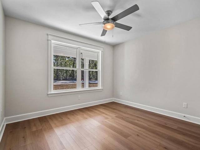 spare room featuring wood-type flooring and ceiling fan