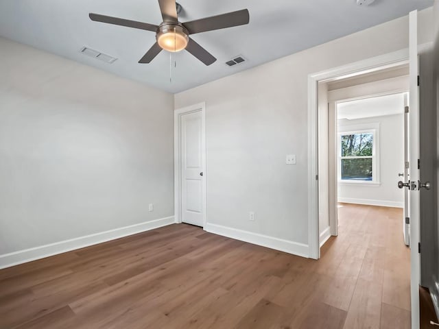 unfurnished bedroom featuring hardwood / wood-style flooring and ceiling fan