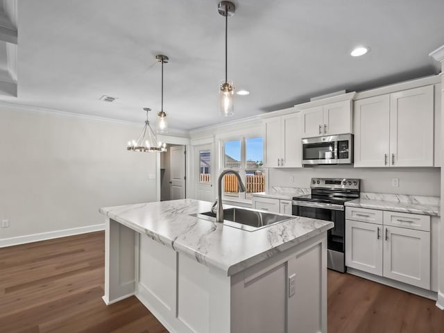 kitchen featuring white cabinetry, stainless steel appliances, decorative light fixtures, and sink