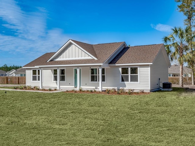 view of front of property with central AC unit, a front lawn, and covered porch