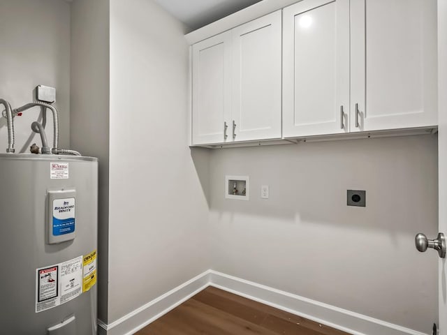 clothes washing area featuring cabinets, dark hardwood / wood-style flooring, hookup for a washing machine, electric dryer hookup, and water heater