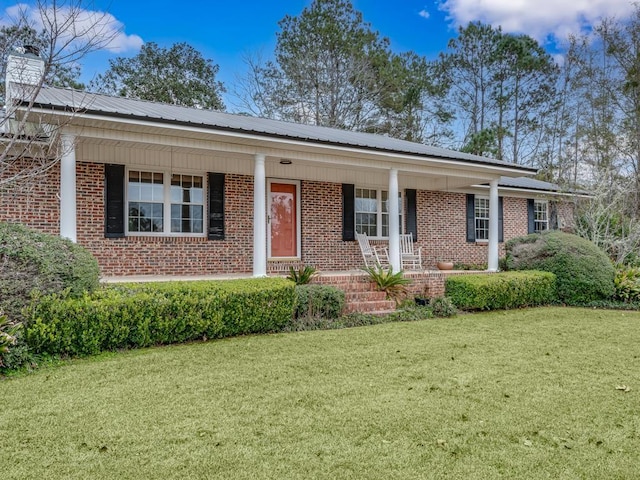 ranch-style home featuring a porch and a front yard