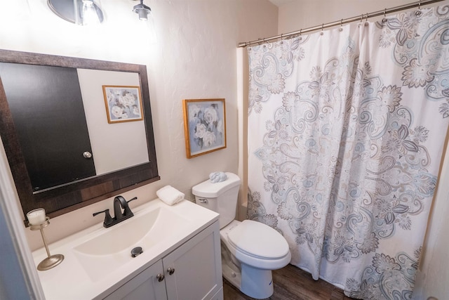 bathroom featuring hardwood / wood-style flooring, vanity, and toilet