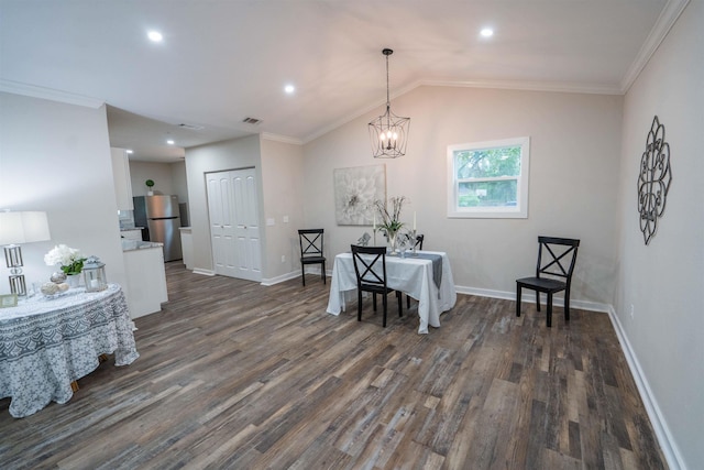 dining area with vaulted ceiling, crown molding, a chandelier, and dark hardwood / wood-style floors