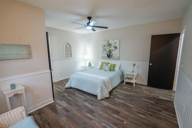 bedroom featuring ceiling fan and dark wood-type flooring