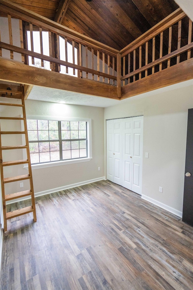 unfurnished living room featuring wood ceiling, high vaulted ceiling, and wood-type flooring