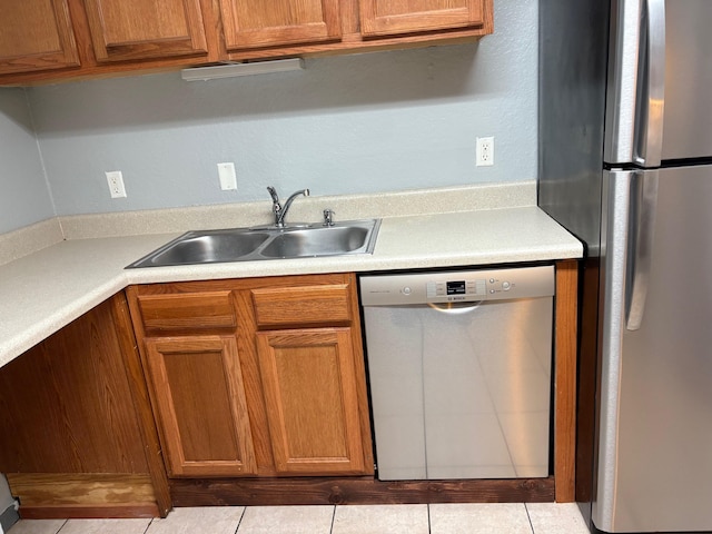 2020 Continental Ave Unit 120, Tallahassee, FL 32304 - kitchen featuring appliances with stainless steel finishes, light countertops, brown cabinets, and tile patterned floors